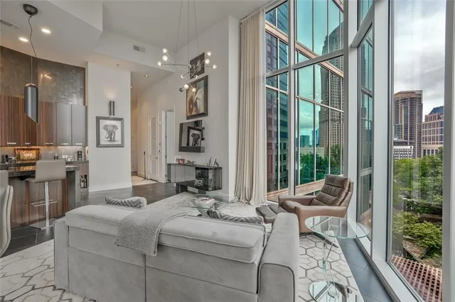 a living room with furniture and large windows