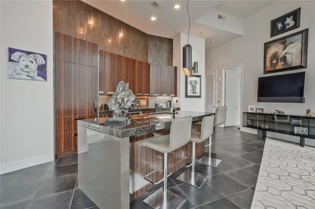 a kitchen with stainless steel appliances kitchen island granite countertop a stove a sink and a microwave