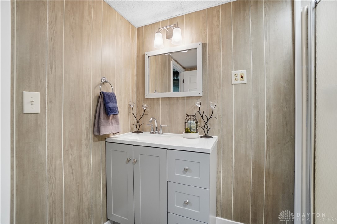 7553 Coffin Station Road Springfield, OH 45502 - Photo 74 of 95 This functional bathroom features a single vanity, a sleek mirror, and modern lighting.