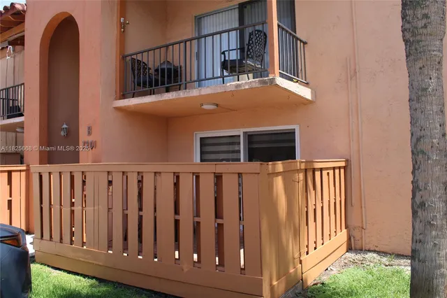 a view of a house with wooden fence