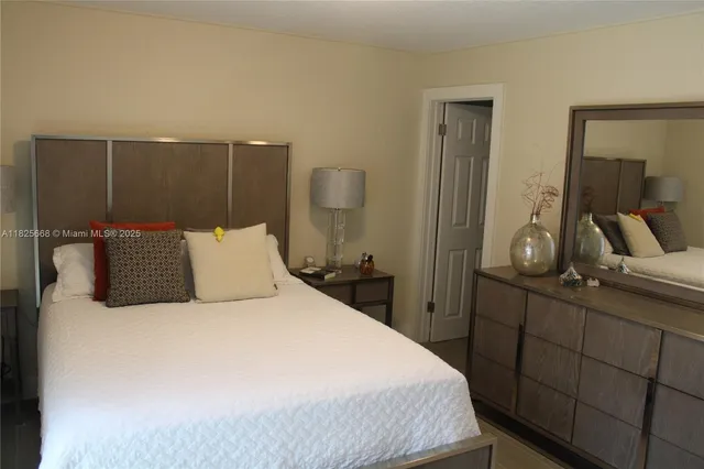 a bedroom with a large bed and a closet