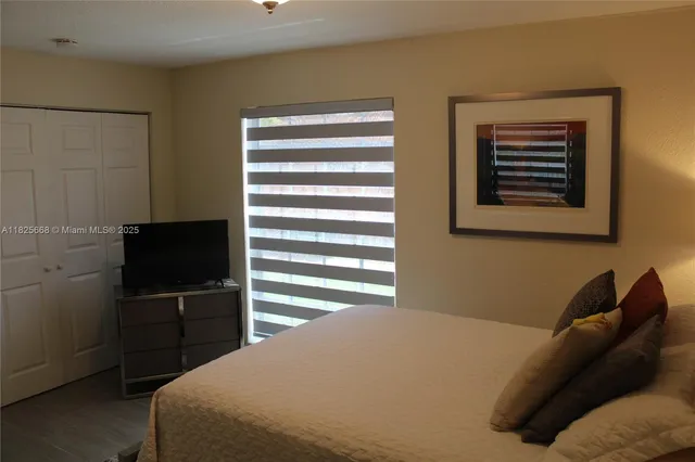 a bedroom with a bed and a lamp