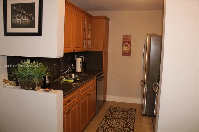 a kitchen with a sink and refrigerator