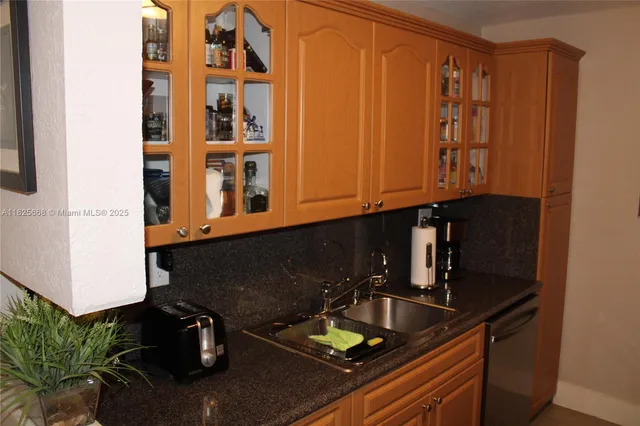 a kitchen with a sink and cabinets