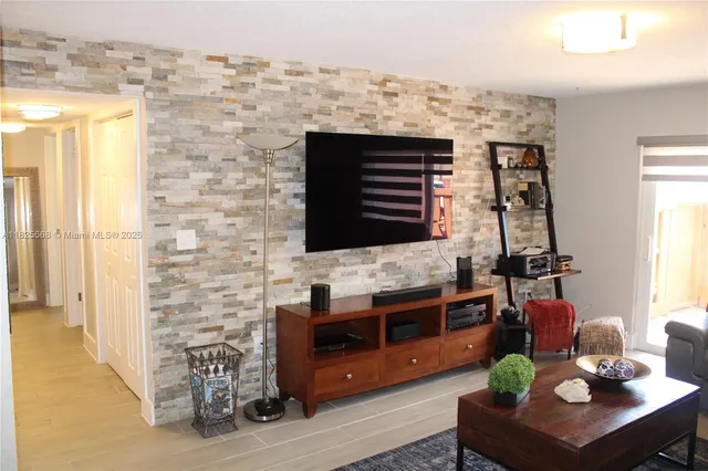 a living room with fireplace furniture and a flat screen tv
