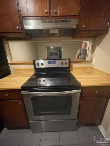 a stove top oven sitting inside of a kitchen