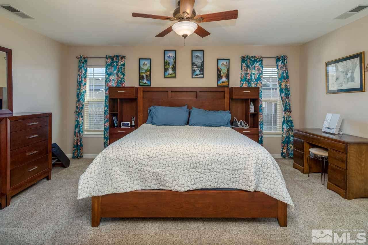 8930 Grisom Way Reno, NV 89506 - Photo 9 of 19 a bedroom with a bed and dresser