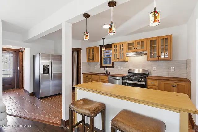 a kitchen with stainless steel appliances granite countertop a sink and refrigerator