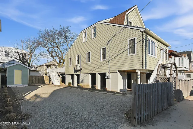 a view of a white house with large windows