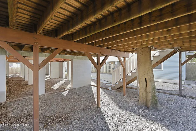 a living room with furniture and a dining table with wooden floor