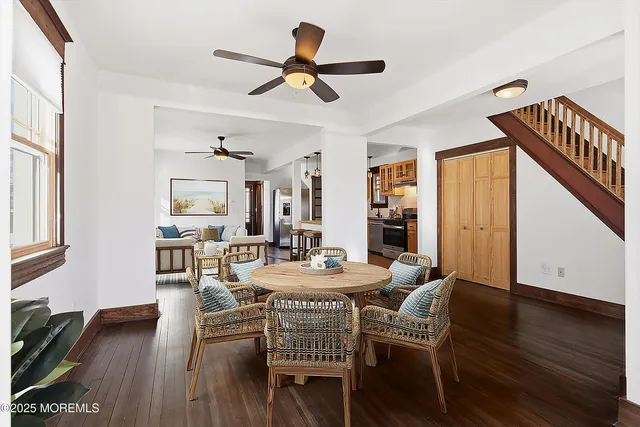 a view of a dining room with furniture and wooden floor