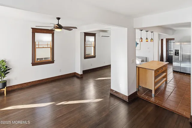 a view of a livingroom with furniture wooden floor and windows