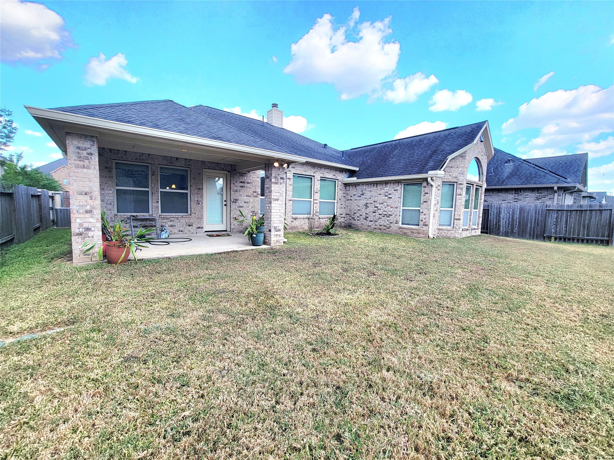 142 Round Lake Drive Rosenberg, TX 77469 - Photo 11 of 14 Big yard, brick vs siding, covered patio.
