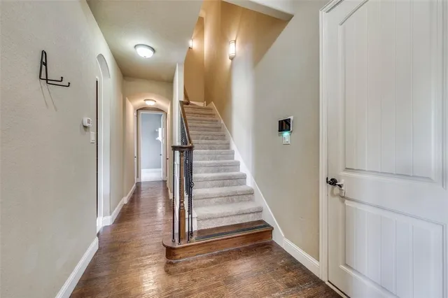 a view of a livingroom with a chandelier fan and windows