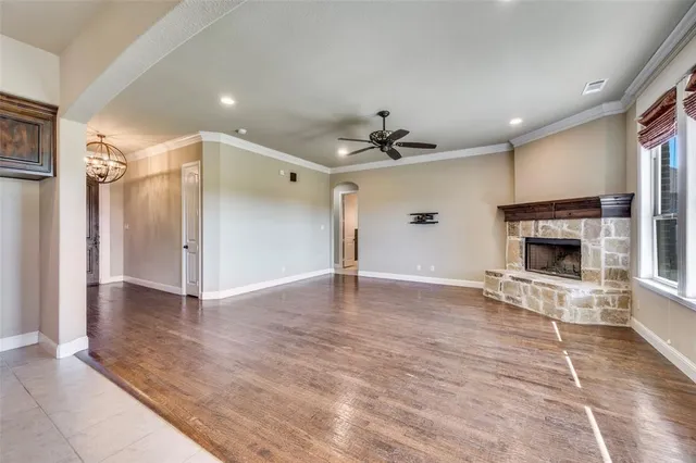 a view of empty room with a fireplace and fan
