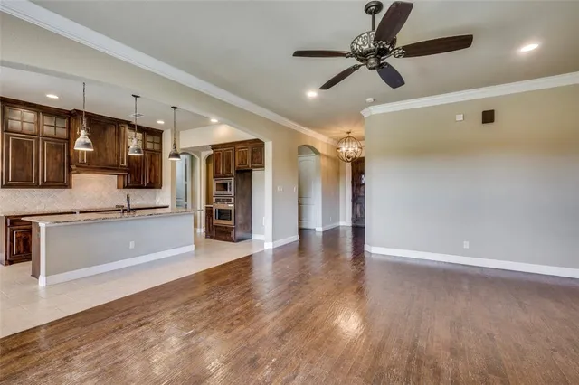 a view of a kitchen with a sink stainless steel appliances and cabinets