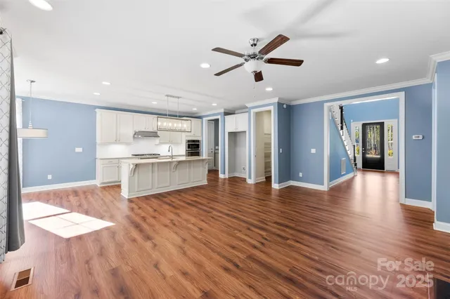 a view of a kitchen with wooden floor and a kitchen