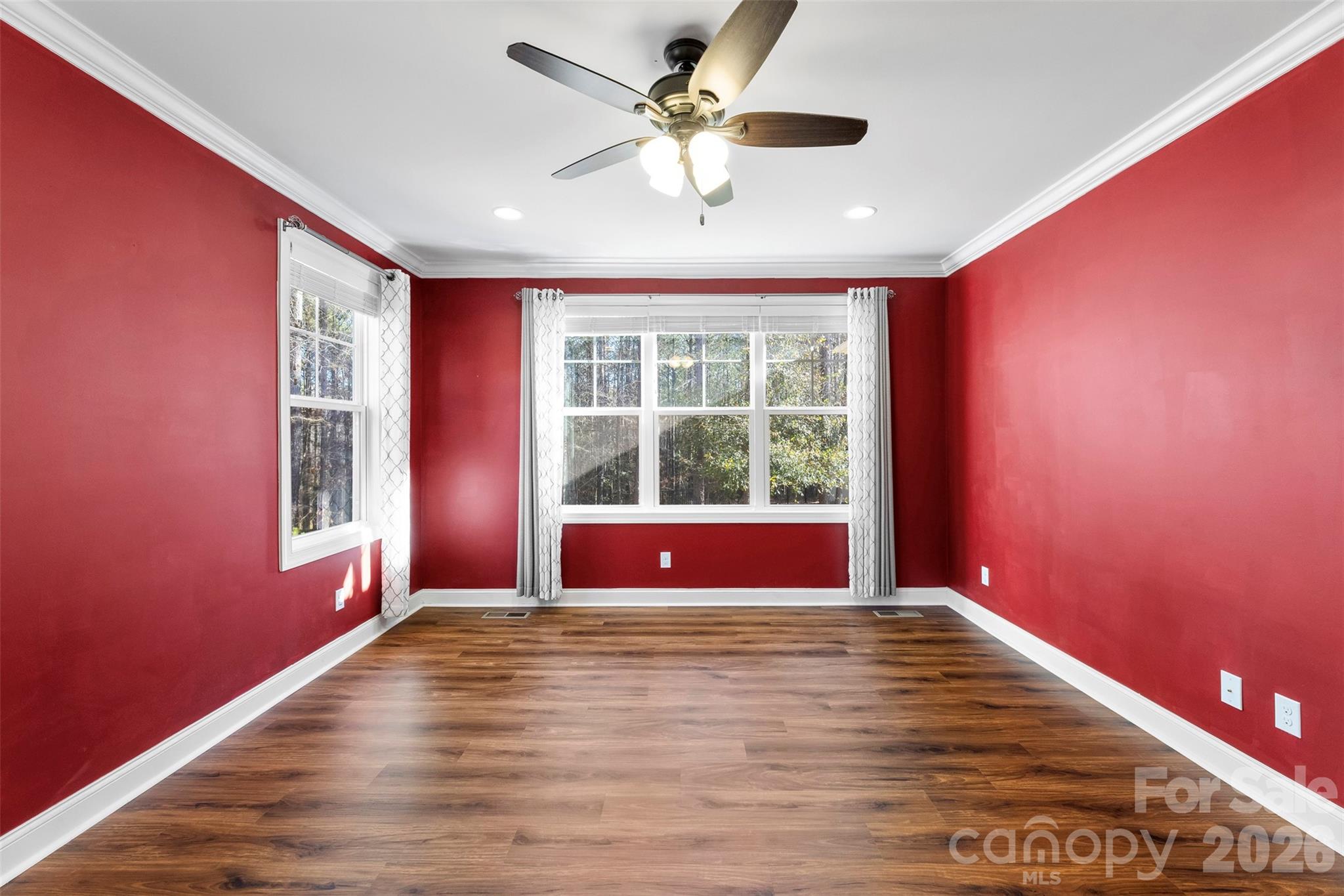 6065 Chimney Bluff Road Lancaster, SC 29720 - Photo 16 of 43 a view of an empty room with wooden floor and a window