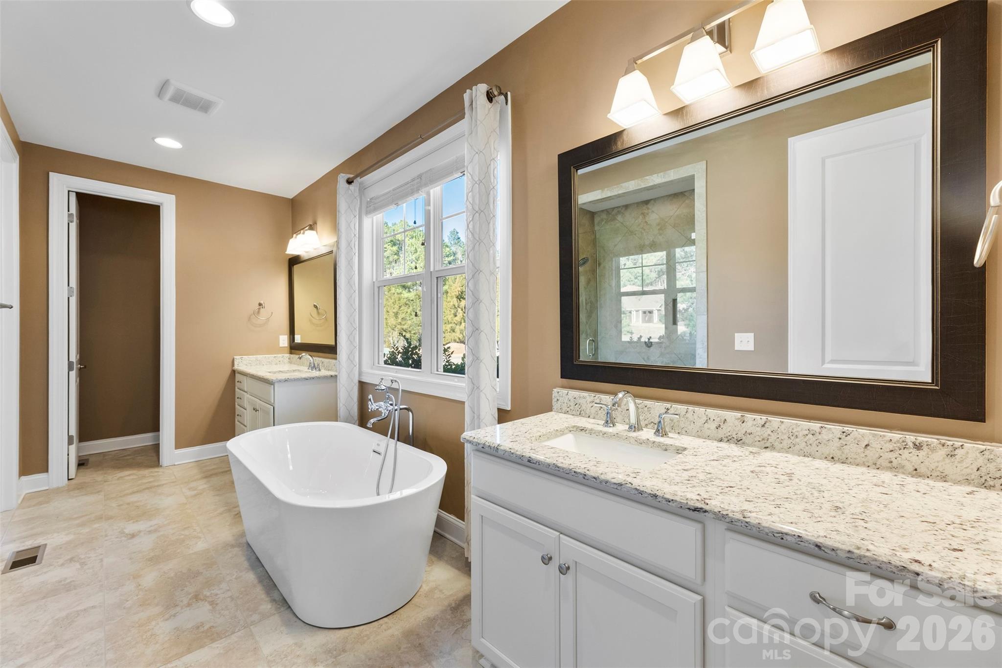 6065 Chimney Bluff Road Lancaster, SC 29720 - Photo 18 of 43 a bathroom with a granite countertop sink and a bathtub