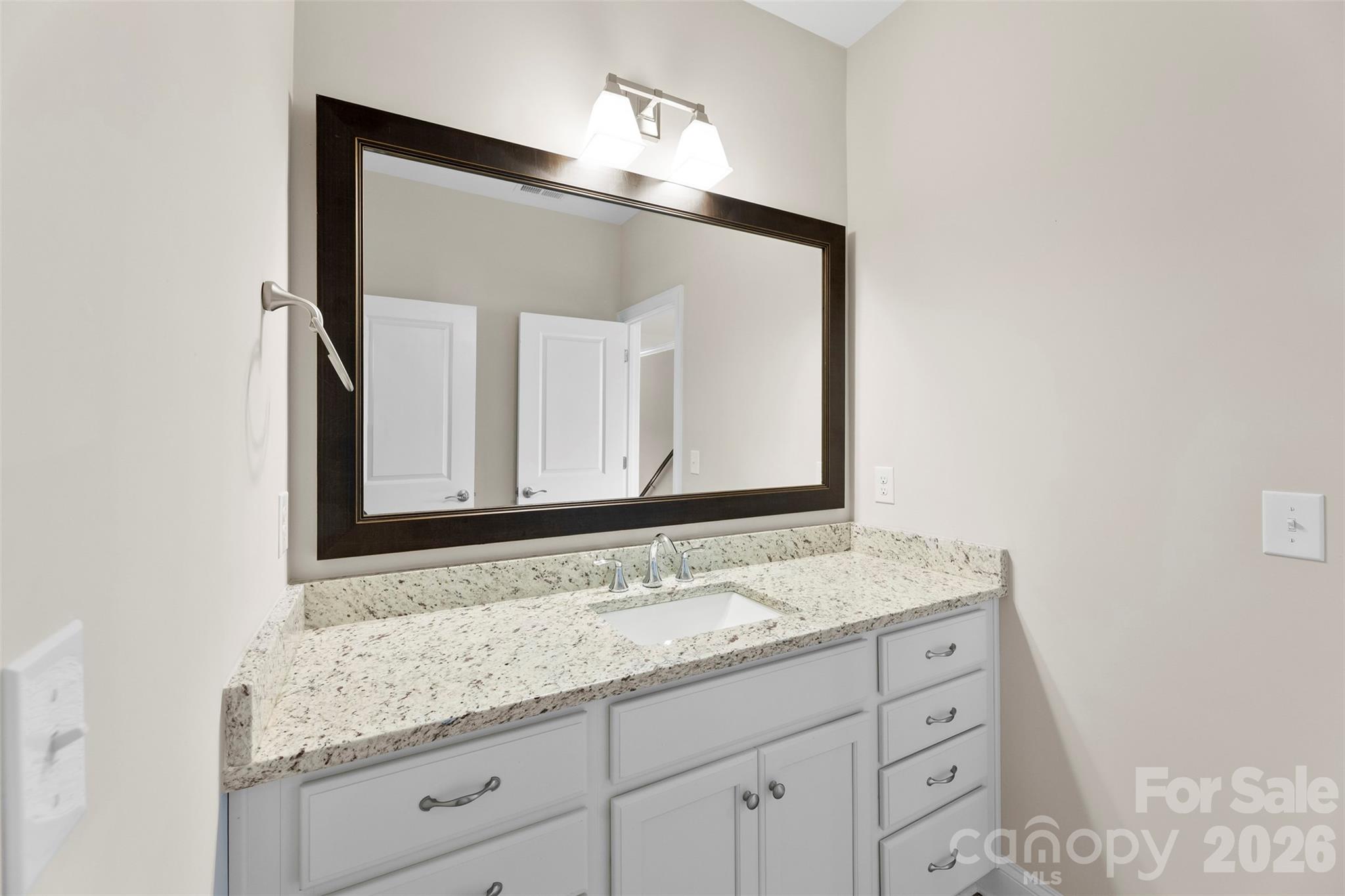 6065 Chimney Bluff Road Lancaster, SC 29720 - Photo 30 of 43 a bathroom with a granite countertop sink and a mirror