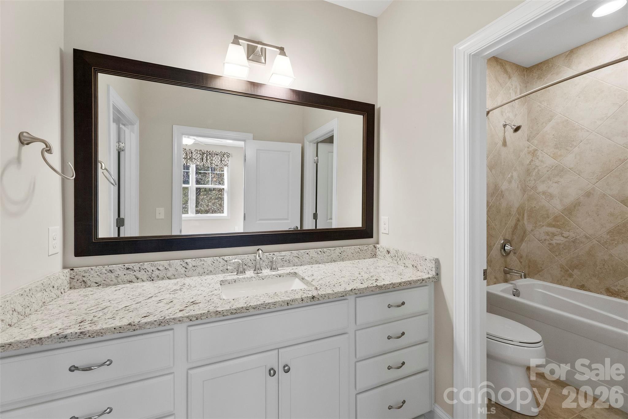 6065 Chimney Bluff Road Lancaster, SC 29720 - Photo 33 of 43 a bathroom with a granite countertop sink toilet and shower