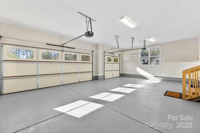 a view of a house with a wooden deck and a trees