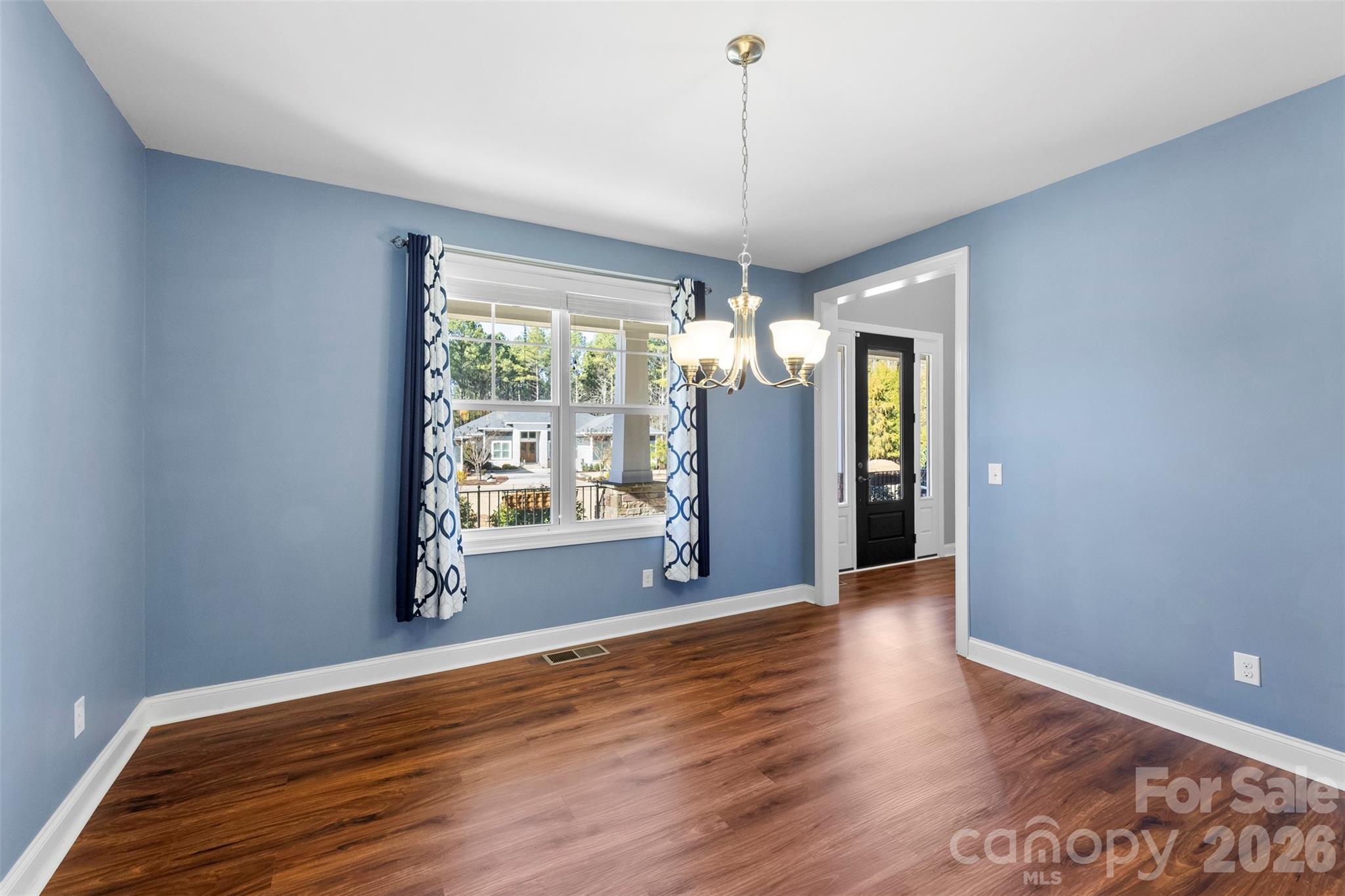 6065 Chimney Bluff Road Lancaster, SC 29720 - Photo 7 of 43 a view of an empty room with wooden floor and a window