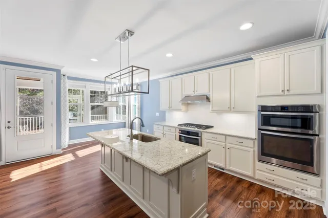 a kitchen with granite countertop counter space a sink appliances and cabinets