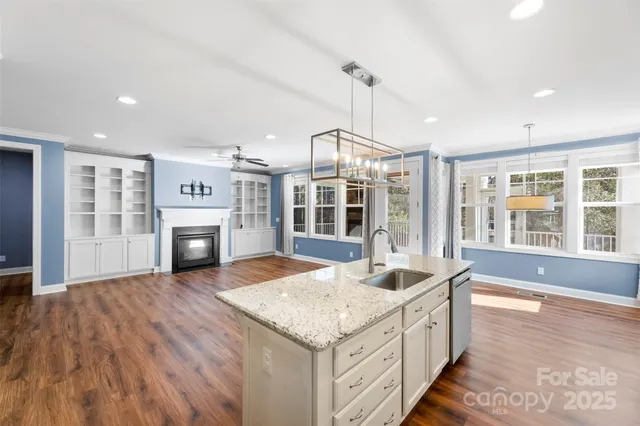 a kitchen with sink and refrigerator