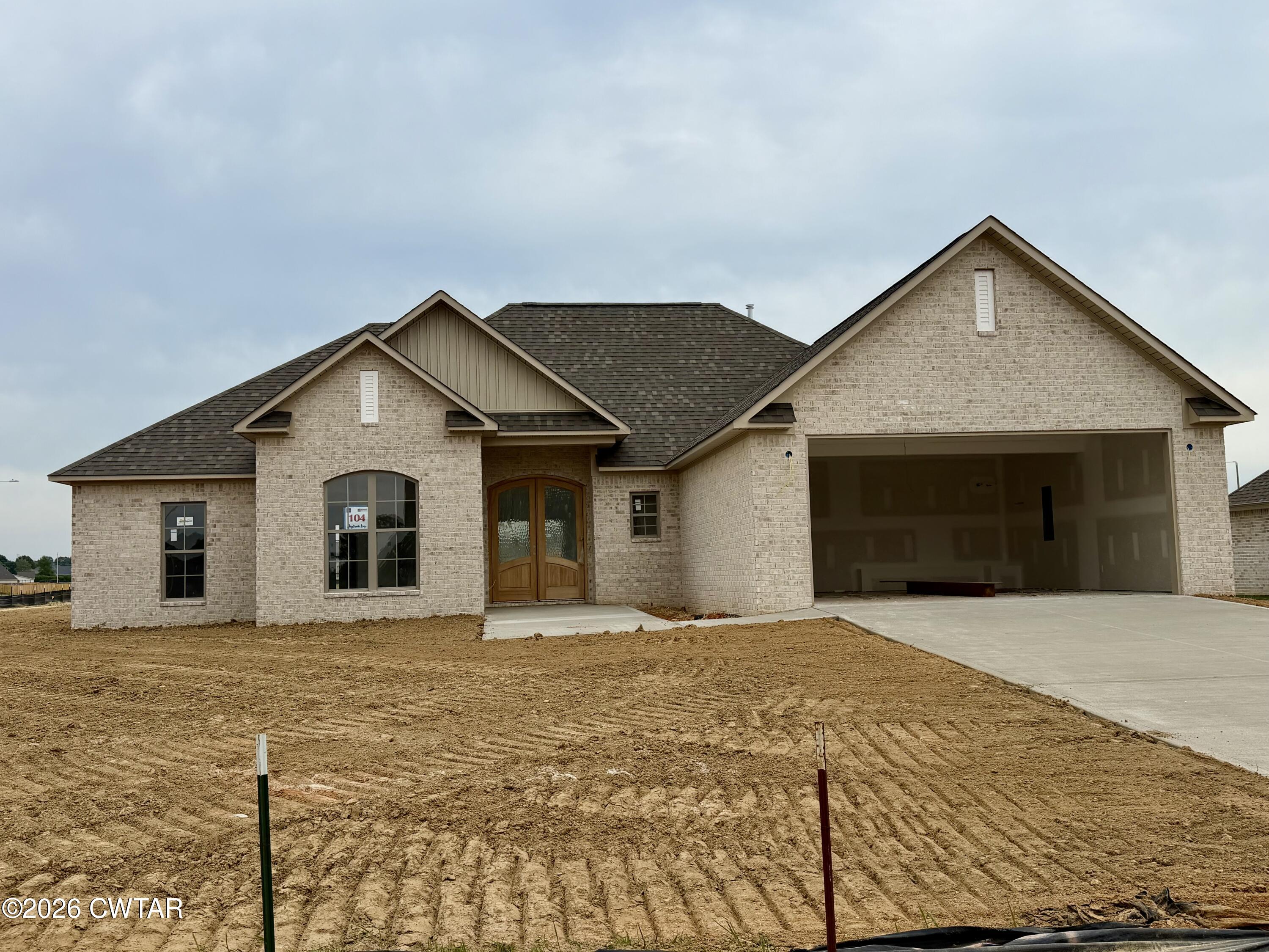 104 Daybreak Loop Medina, TN 38355 - Photo 2 of 3 a view of house with yard and garage