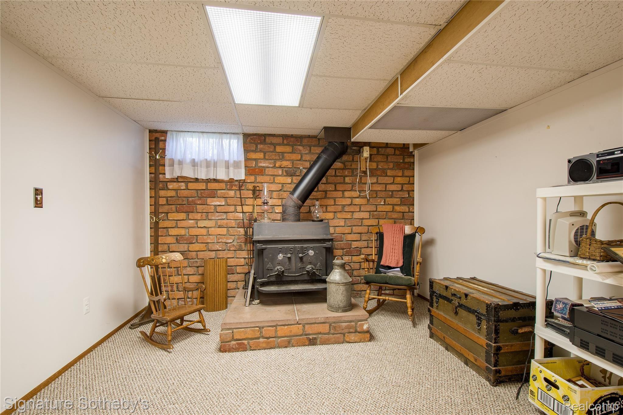 2500 South Hickory Ridge Road Milford, MI 48380 - Photo 20 of 40 Brick accent wall for wood burning stove