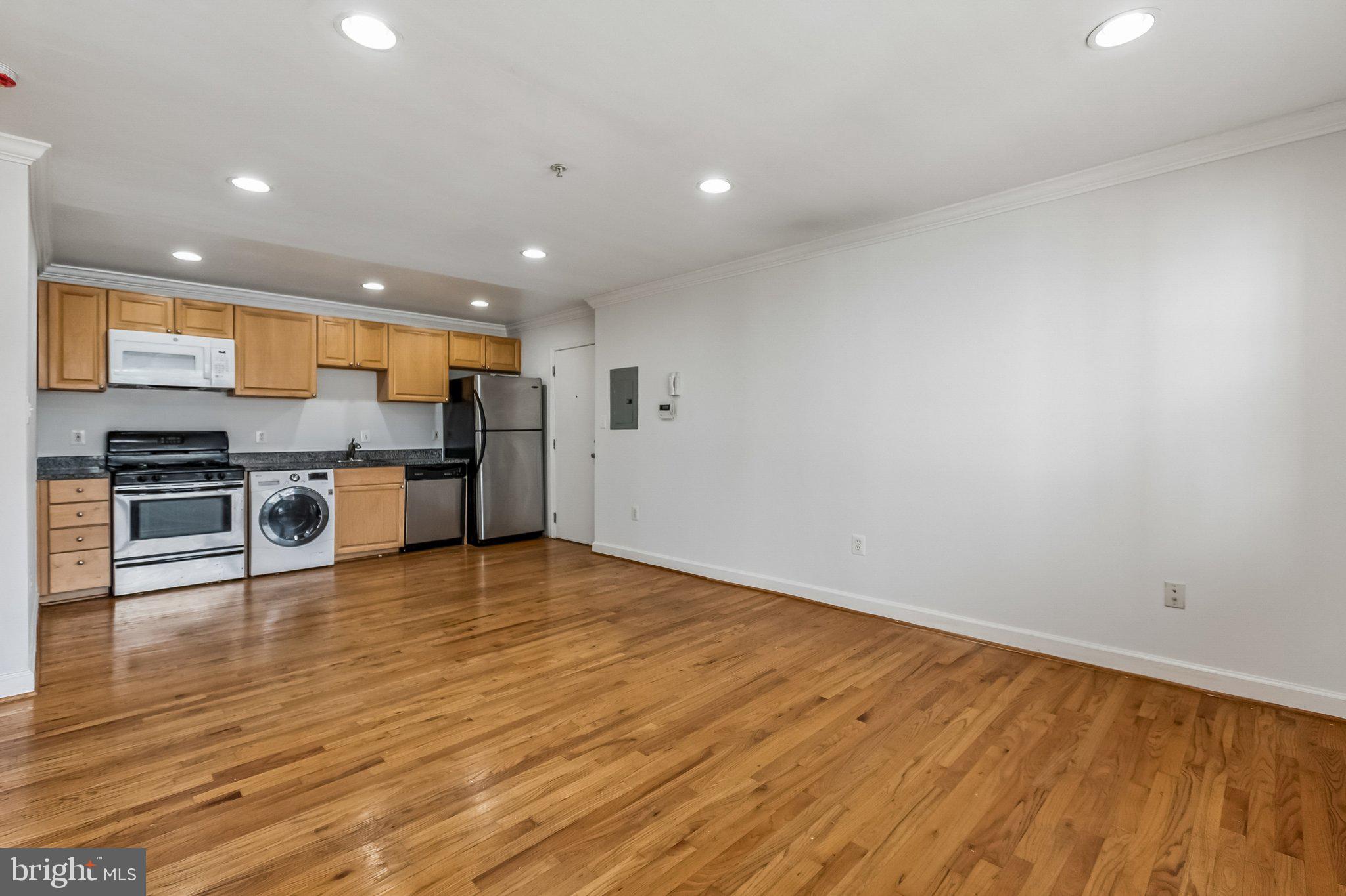 723 Longfellow Street Northwest, Unit 102 Washington, DC 20011 - Photo 8 of 17 a view of kitchen with kitchen island microwave and stove