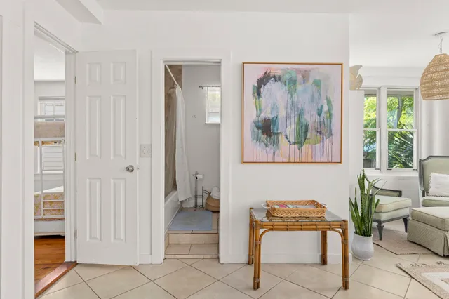 a view of a hallway with workspace and a couch