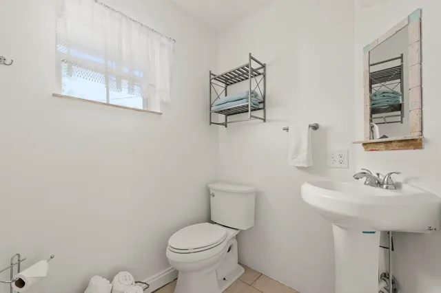 a bathroom with a sink mirror and toilet