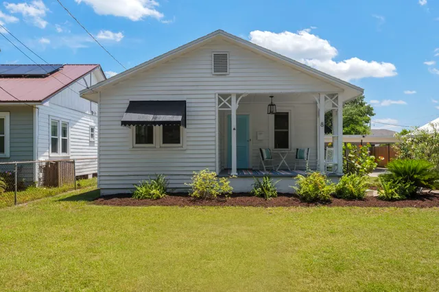 a view of a patio with table and chairs and potted plants