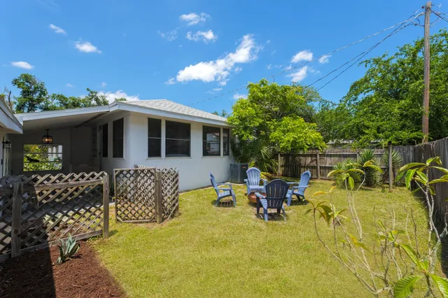 a view of a house with backyard porch and sitting area