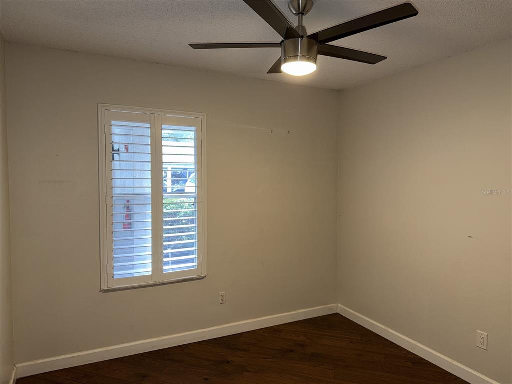 550 Cranes Way, Unit 116 Altamonte Springs, FL 32701 - Photo 11 of 29 an empty room with wooden floor fan and windows