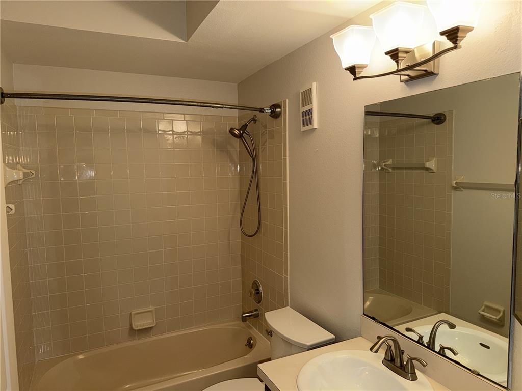 550 Cranes Way, Unit 116 Altamonte Springs, FL 32701 - Photo 13 of 29 a bathroom with a granite countertop bathtub shower sink vanity and toilet