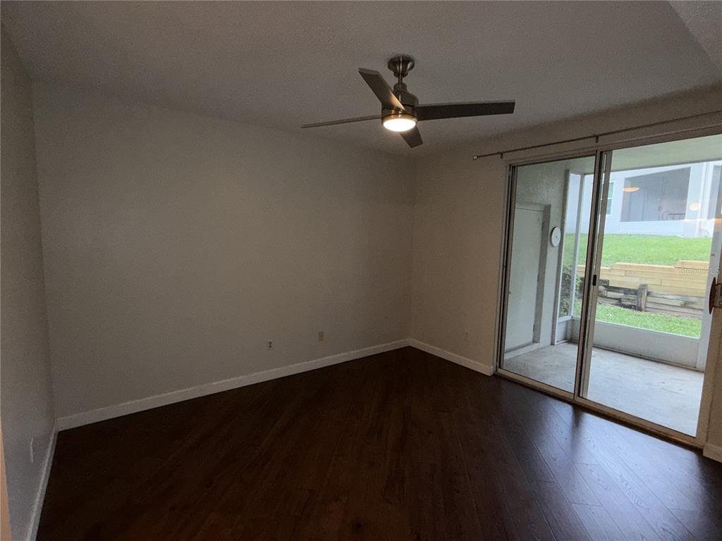 550 Cranes Way, Unit 116 Altamonte Springs, FL 32701 - Photo 19 of 29 an empty room with wooden floor fan and windows