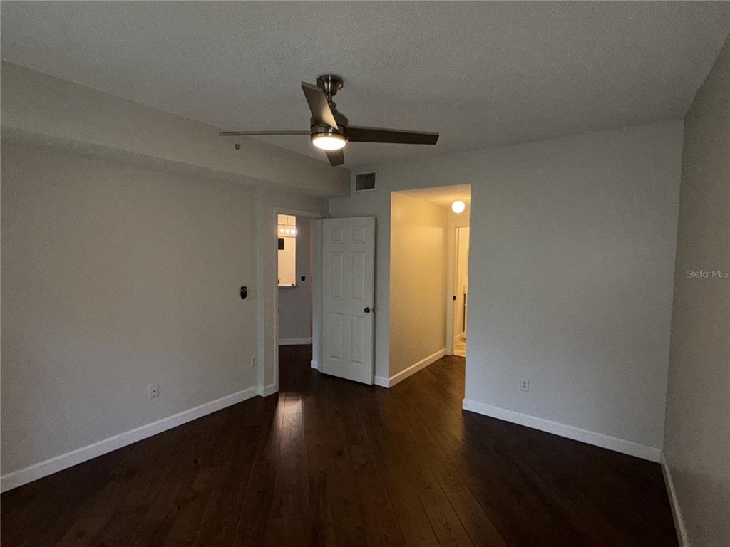 550 Cranes Way, Unit 116 Altamonte Springs, FL 32701 - Photo 20 of 29 an empty room with wooden floor and windows