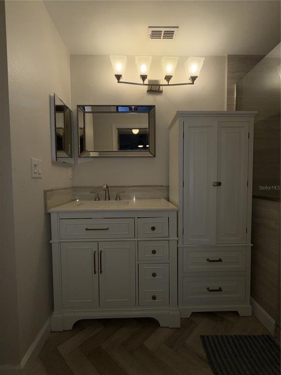 550 Cranes Way, Unit 116 Altamonte Springs, FL 32701 - Photo 24 of 29 a bathroom with a sink and a mirror
