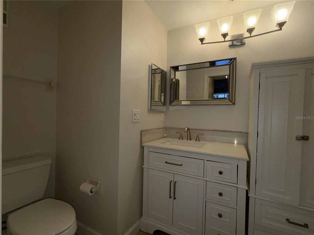 550 Cranes Way, Unit 116 Altamonte Springs, FL 32701 - Photo 25 of 29 a bathroom with a toilet sink vanity and mirror