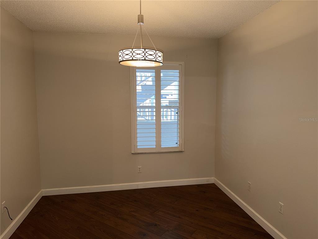550 Cranes Way, Unit 116 Altamonte Springs, FL 32701 - Photo 4 of 29 wooden floor in an empty room with a window