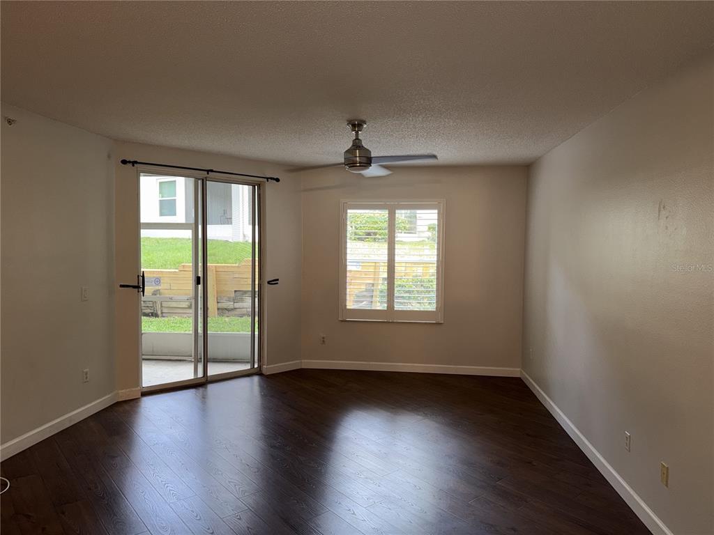 550 Cranes Way, Unit 116 Altamonte Springs, FL 32701 - Photo 9 of 29 an empty room with wooden floor and windows