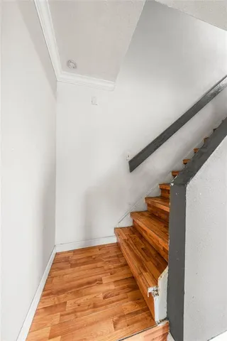 a view of a room with wooden floor