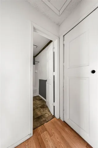 a view of a hallway with wooden floor and entryway