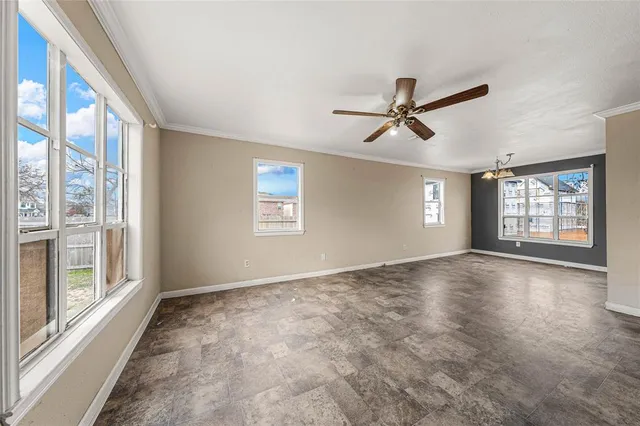 a view of a livingroom with a ceiling fan and window