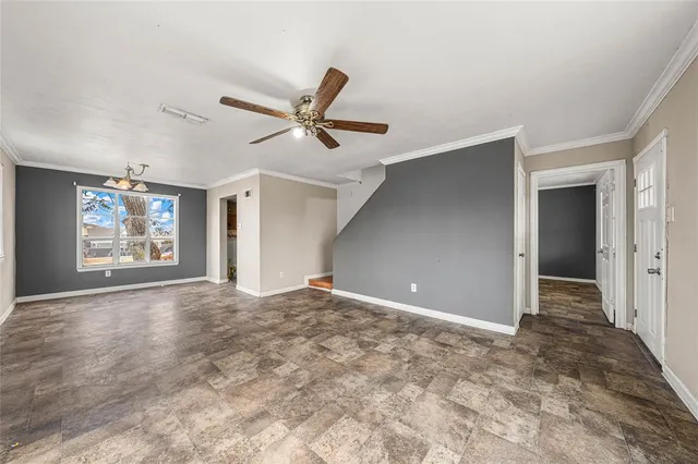 an empty room with closet and windows