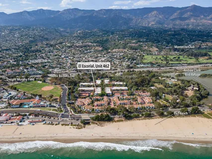 an aerial view of residential house and sandy dunes