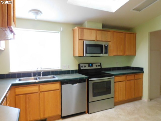 145 River Road Junction City, OR 97448 - Photo 16 of 35 a kitchen with stainless steel appliances granite countertop a stove a sink and a microwave